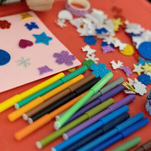A vibrant assortment of arts and crafts materials on a table, perfect for creativity and decoration projects.