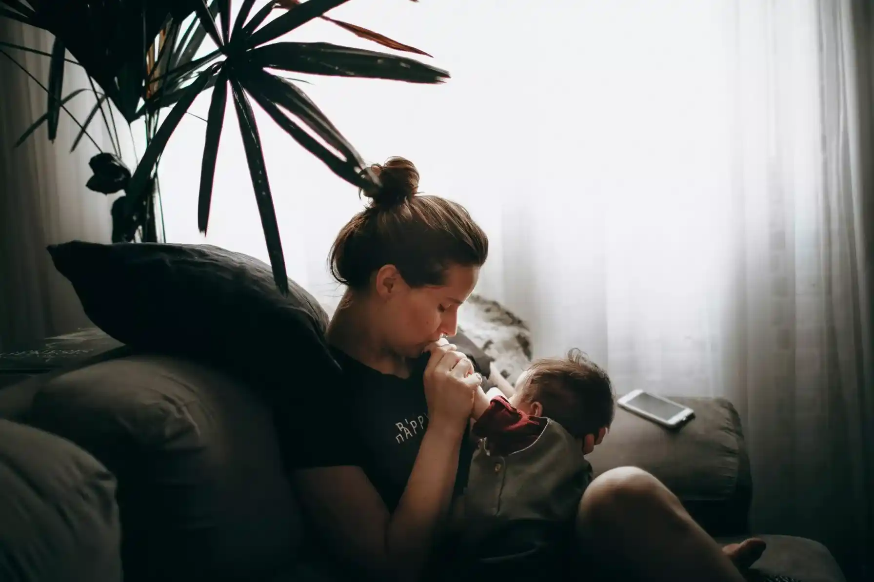Parent feeding a smiling baby with nutritious food as part of Baby Care
