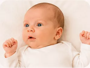 Parent giving a baby a warm bath during a Baby Care routine