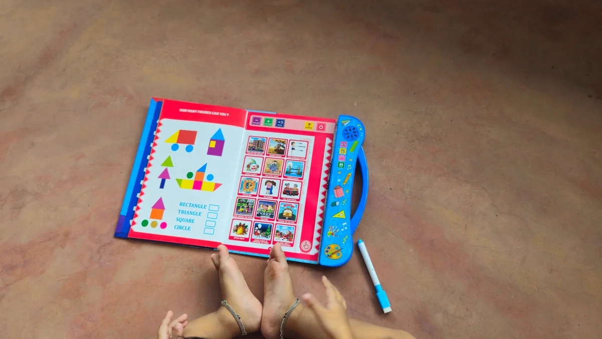  Open pages of an interactive learning book showing alphabet, numbers, fruits, animals and vehicle activities